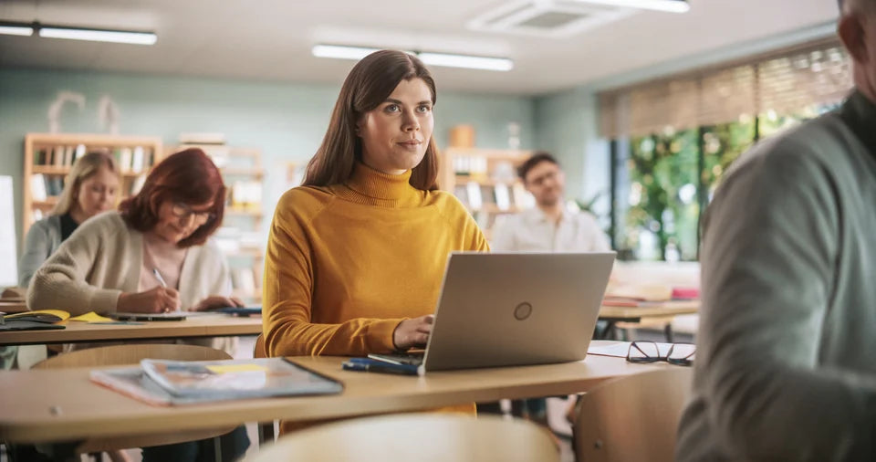 Adult learners building skills in a classroom
