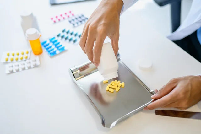 A pharmacist preparing medicines at a dispensing bench