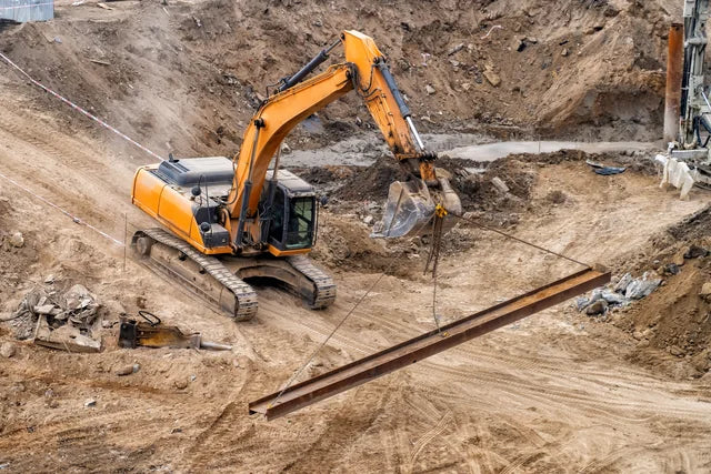 An excavator lifting materials on a construction site
