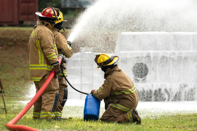 Firefighters practising hose operation during a training exercise