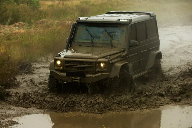 A four-wheel-drive vehicle travelling along a forest track