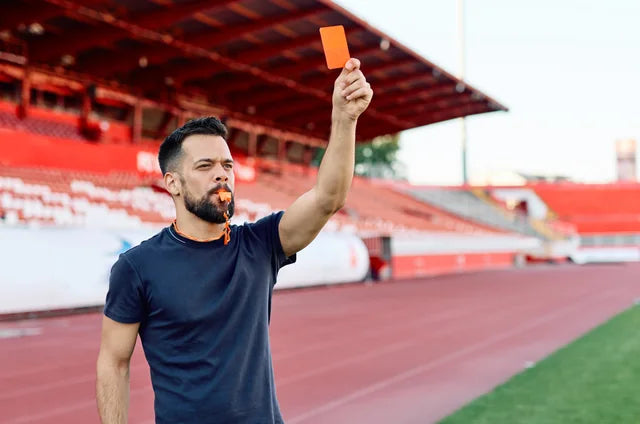 A sports official signalling on the field