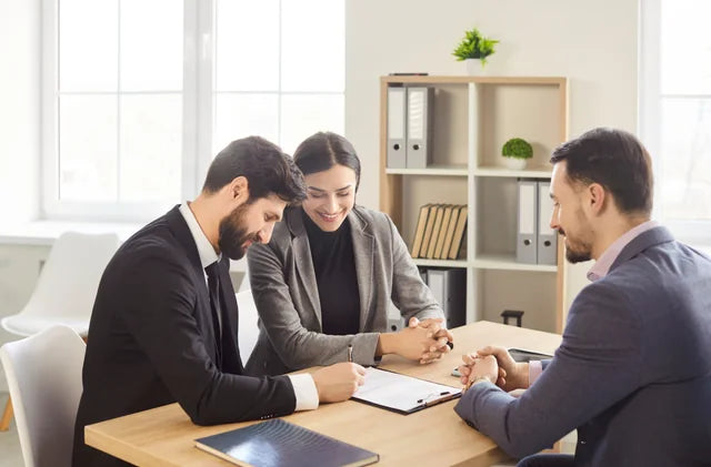 Clients discussing documents with a financial adviser