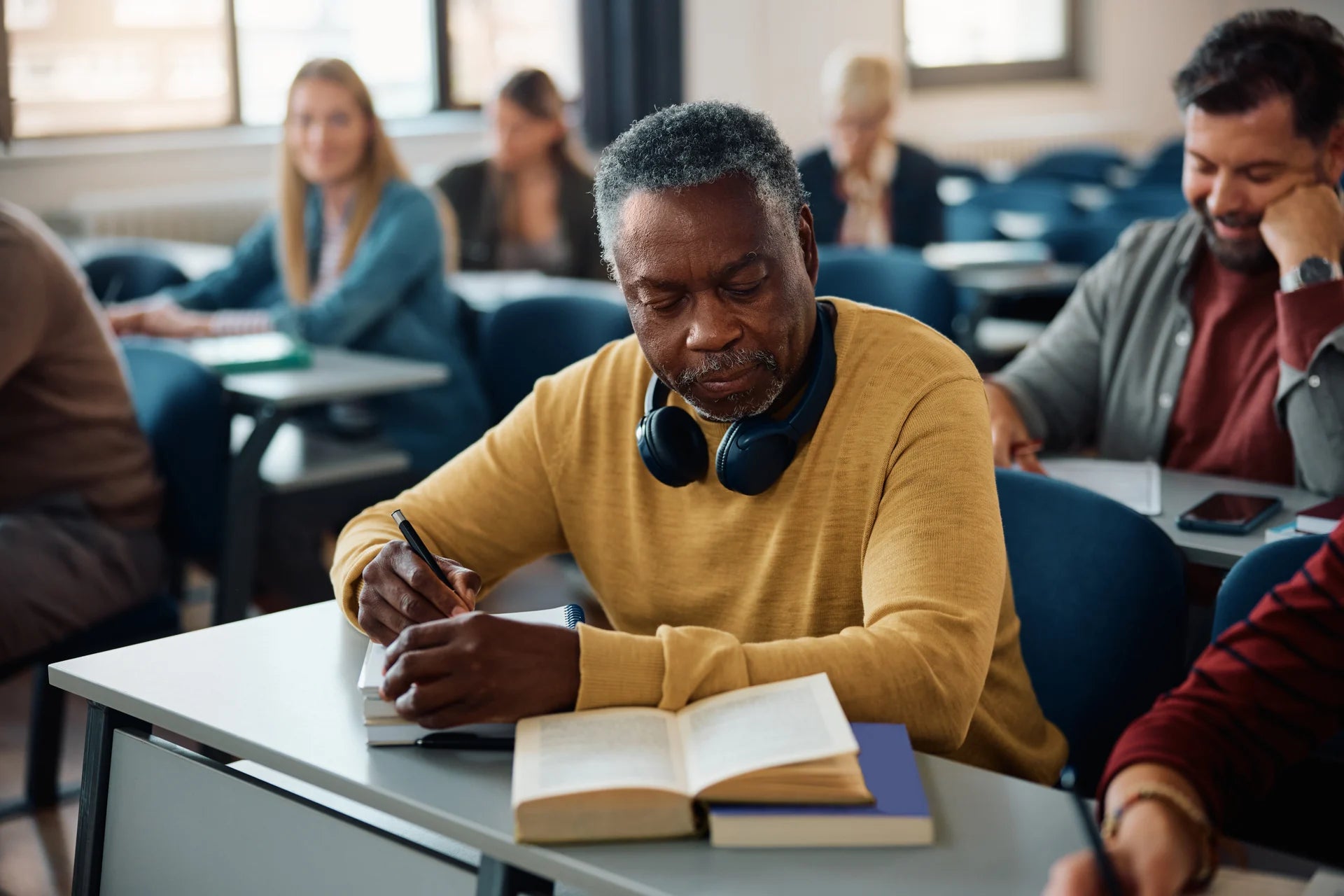 An adult learner reviewing written work in class