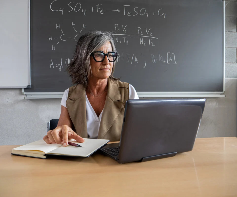 An educator preparing lessons at her desk