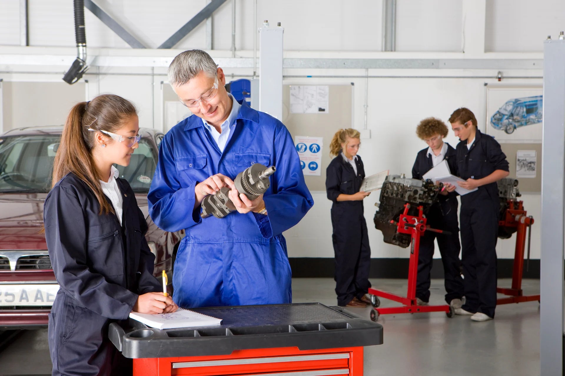 An automotive trainer demonstrating a component