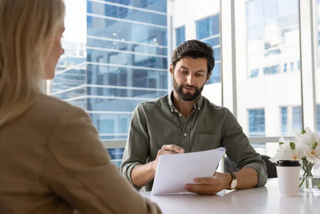 A professional reviewing documents during an interview